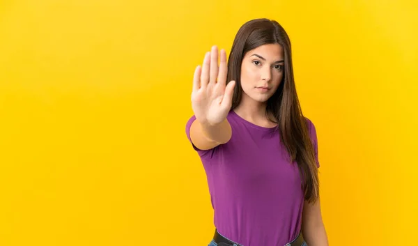 Teenager Brazilian Girl Isolated Yellow Background Making Stop Gesture — Stockfoto
