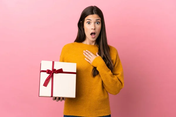 Teenager Brazilian Girl Holding Gift Isolated Pink Background Surprised Shocked — 스톡 사진