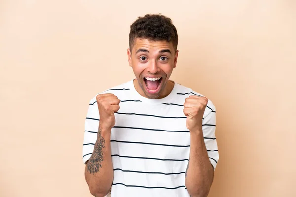 Young Brazilian Man Isolated Beige Background Celebrating Victory Winner Position — Stock fotografie