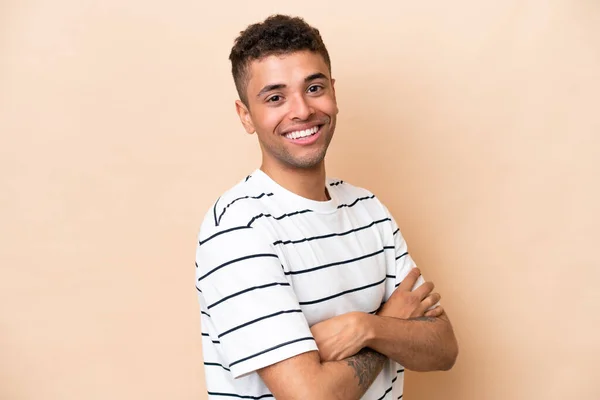 Young Brazilian Man Isolated Beige Background Arms Crossed Looking Forward — Stockfoto