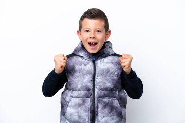 Little boy isolated on white background celebrating a victory in winner position