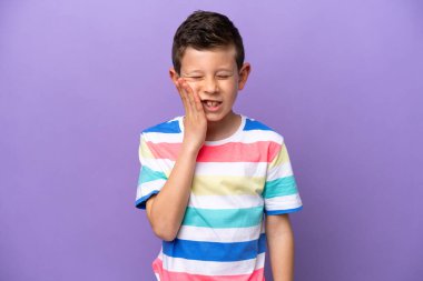 Little boy isolated on purple background with toothache