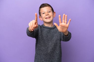 Little boy isolated on purple background counting six with fingers