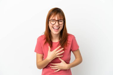 Redhead girl isolated on white background smiling a lot
