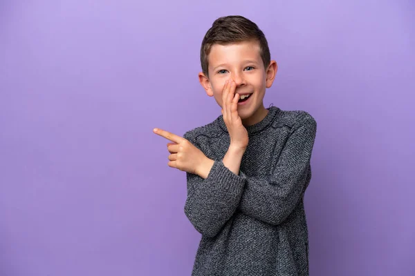 Little Boy Isolated Purple Background Pointing Side Present Product Whispering — Foto Stock