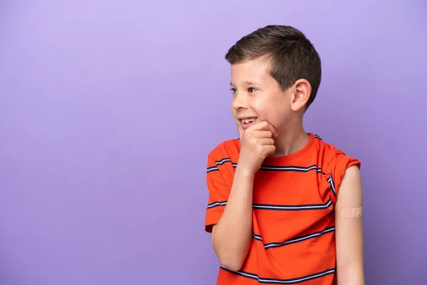 Little Boy Wearing Band Aid Isolated Purple Background Thinking Idea — Foto de Stock