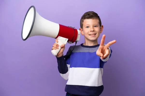 Little Boy Isolated Purple Background Holding Megaphone Smiling Showing Victory — Zdjęcie stockowe