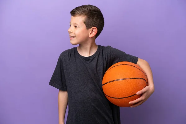 Little Boy Playing Basketball Isolated Purple Background Looking Side — Foto de Stock