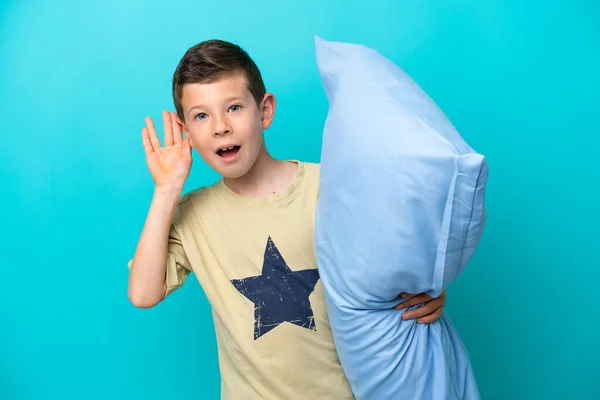 Little Boy Pajamas Isolated Blue Background Listening Something Putting Hand — Photo
