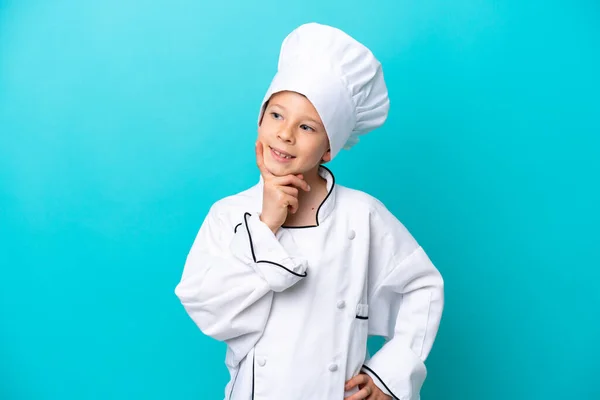 Little Chef Boy Isolated Blue Background Thinking Idea While Looking — Foto de Stock