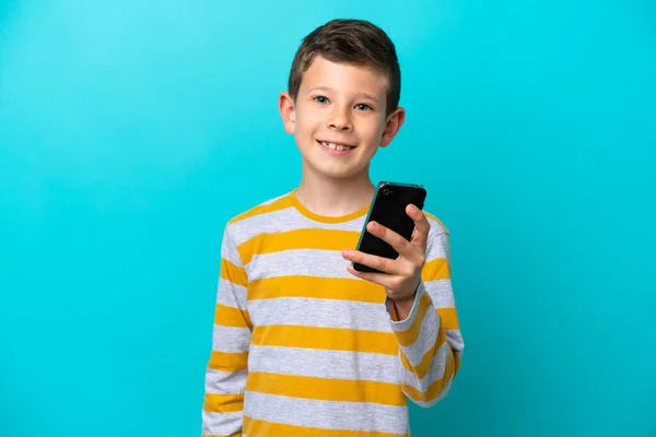 Little Boy Isolated Blue Background Using Mobile Phone — Stock Photo, Image