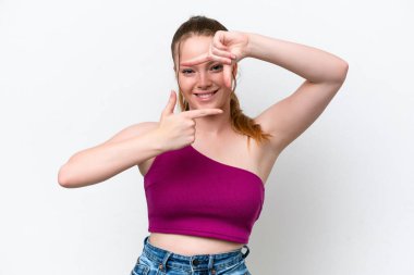Young caucasian girl isolated on white background focusing face. Framing symbol