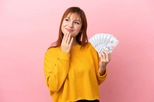 Redhead Girl Taking Lot Money Isolated Pink Background Looking While — Stock fotografie