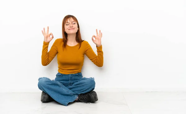 Redhead Girl Sitting Floor Isolated White Background Zen Pose — Stockfoto