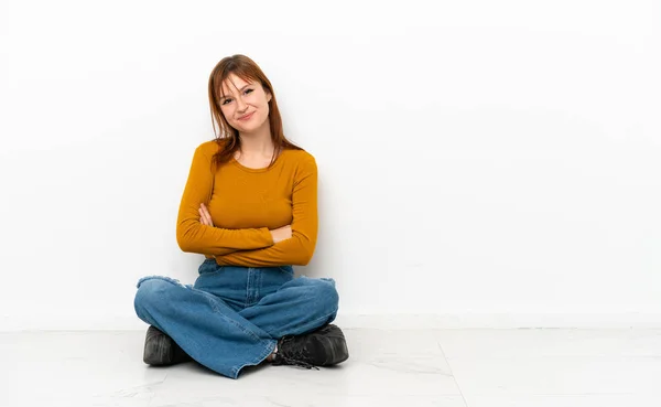 Redhead Girl Sitting Floor Isolated White Background Arms Crossed Looking — Stockfoto