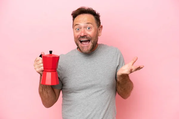 Middle Age Caucasian Man Holding Coffee Pot Isolated Pink Background — Stok fotoğraf