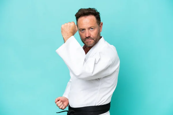 Middle Age Caucasian Man Isolated Blue Background Doing Karate — Foto de Stock