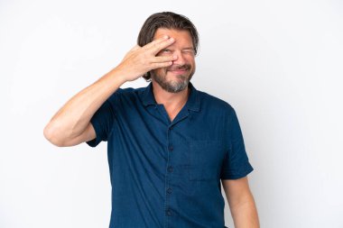 Senior dutch man isolated on white background covering eyes by hands and smiling