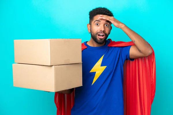 Super Hero Delivery Brazilian Man Isolated Blue Background Surprise Expression — Stock Photo, Image