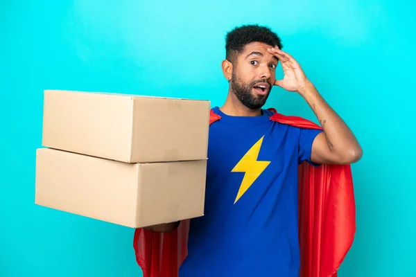 Super Hero Delivery Brazilian Man Isolated Blue Background Doing Surprise — Stock Photo, Image