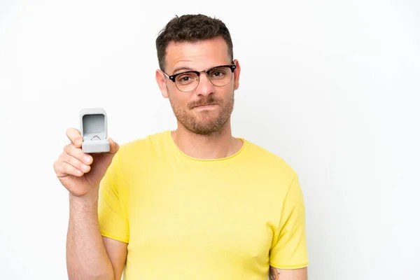 Young Caucasian Man Holding Engagement Ring Isolated White Background Sad — Zdjęcie stockowe