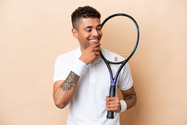 Young Brazilian Handsome Man Playing Tennis Isolated Beige Background Looking — Stockfoto