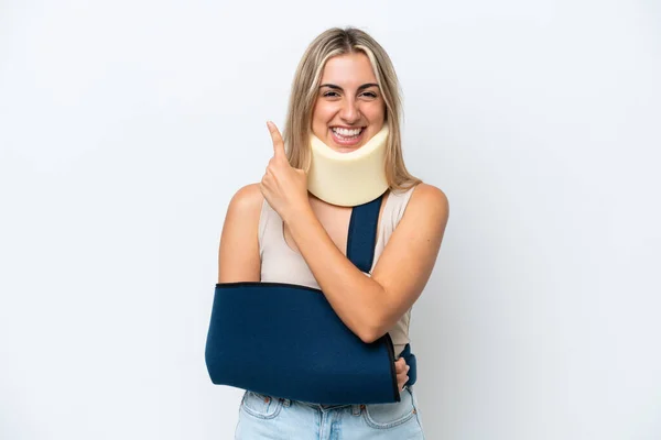 Woman Broken Arm Wearing Sling Isolated White Background Pointing Side —  Fotos de Stock