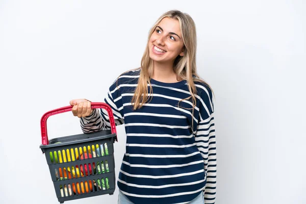 Young Caucasian Woman Holding Shopping Basket Full Food Isolated White — Φωτογραφία Αρχείου