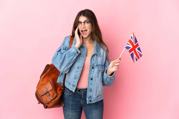Молодая Женщина Флагом Великобритании Розовом Фоне Удивлением Шокированным Выражением Лица — стоковое фото