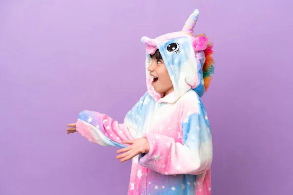Little Kid Wearing Unicorn Pajama Isolated Purple Background Surprise Facial — стоковое фото