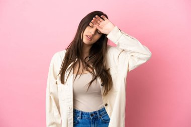 Pembe arka planda izole edilmiş, yorgun ve hasta bir yüzü olan beyaz bir kadın.