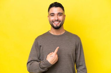 Young Arab handsome man isolated on yellow background with surprise facial expression