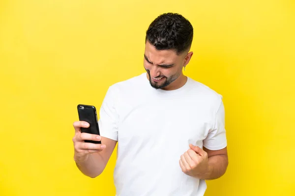 Young Arab Handsome Man Isolated Yellow Background Using Mobile Phone — Stock fotografie