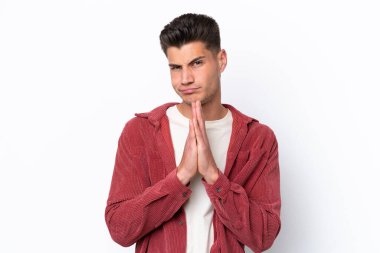 Beyaz arka planda izole genç beyaz adam avuç içlerini bir arada tutuyor. İnsan bir şey ister.