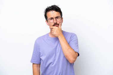 Young man with moustache isolated on white background having doubts