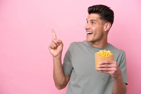 Young Caucasian Man Holding Fried Chips Isolated Pink Background Intending — Stockfoto