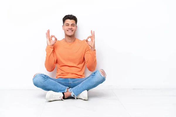 Young Man Sitting Floor Isolated White Background Zen Pose — Stok fotoğraf