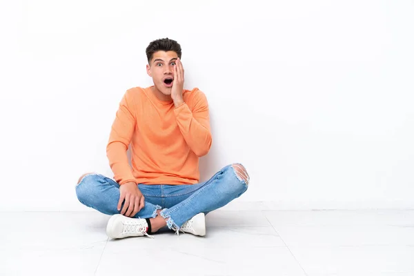 Young Man Sitting Floor Isolated White Background Surprise Shocked Facial — 图库照片