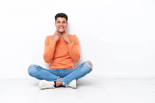 Young Man Sitting Floor Isolated White Background Smiling Happy Pleasant — Stock Fotó