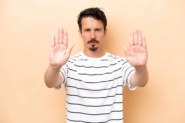 Young Caucasian Man Isolated Beige Background Making Stop Gesture Disappointed — Stock Photo, Image