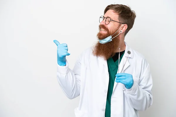 Dentist Reddish Man Holding Tools Isolated White Background Pointing Side — 스톡 사진
