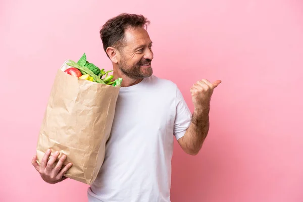 Middle Age Man Holding Grocery Shopping Bag Isolated Pink Background — Φωτογραφία Αρχείου