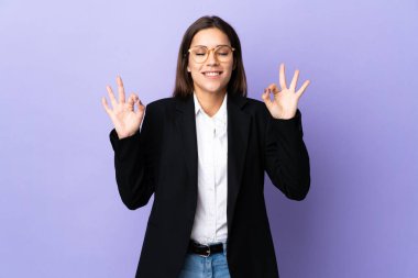 Mor arka planda Zen pozunda yalnız bir iş kadını