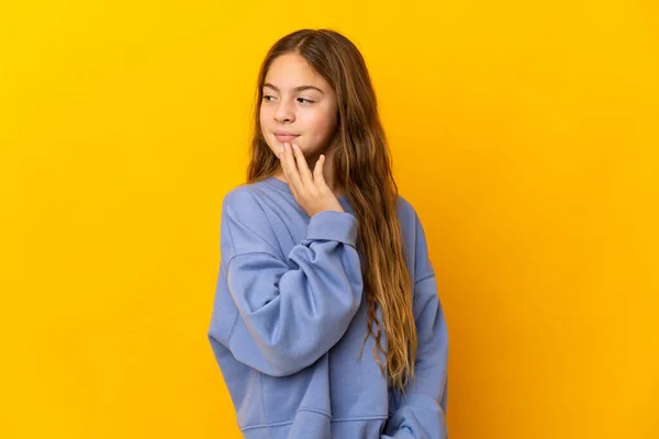 Child Isolated Yellow Background Looking While Smiling — ストック写真