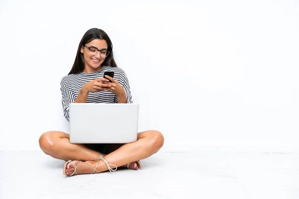 Dizüstü Bilgisayarı Olan Beyaz Bir Kadın Yerde Oturuyor Cep Telefonuyla — Stok fotoğraf