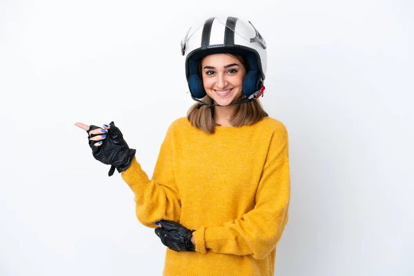 若いですCaucasian女性とともにオートバイヘルメット隔離上の白い背景指差し指へ側 — ストック写真