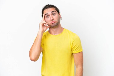 Beyaz arka planda beyaz tenli yakışıklı bir adam bir fikir düşünüyor.