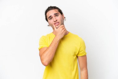 Caucasian handsome man isolated on white background having doubts