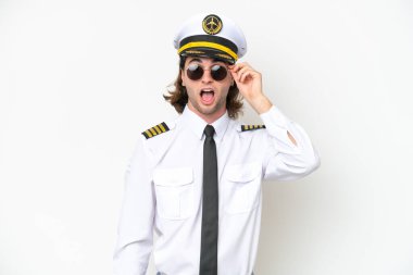handsome Airplane pilot isolated on white background with glasses and surprised