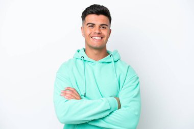 Young caucasian handsome man isolated on white background keeping the arms crossed in frontal position